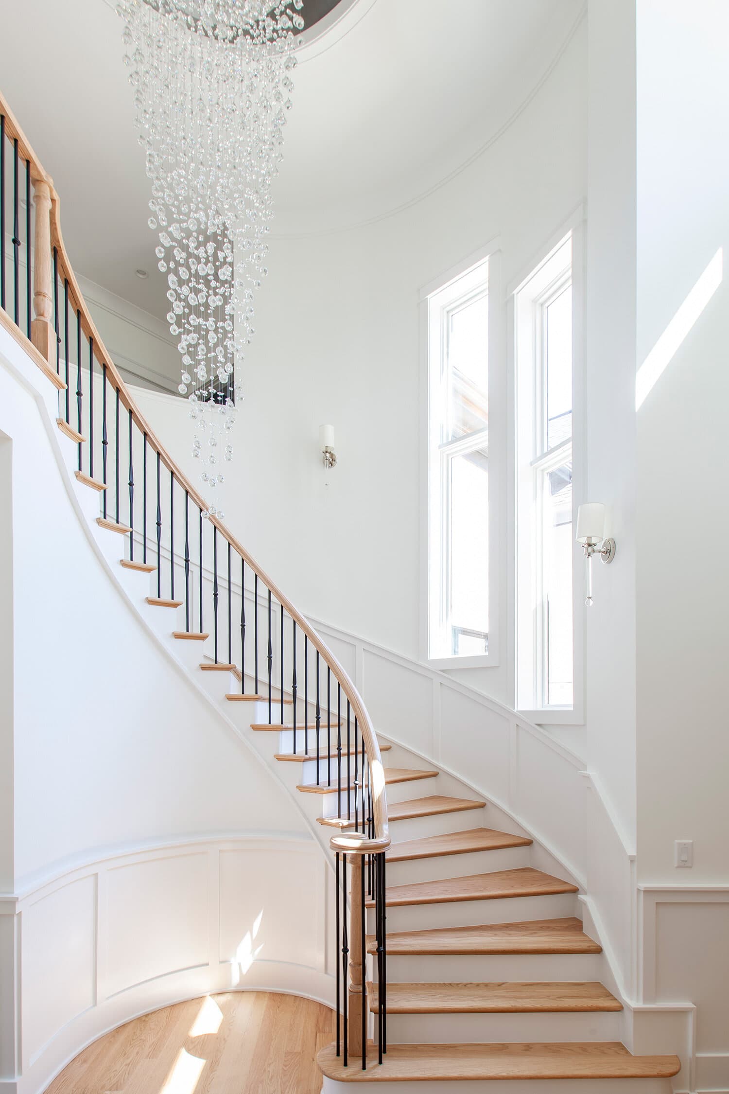 Curved staircase with custom mouldings in custom home, Charlotte, NC