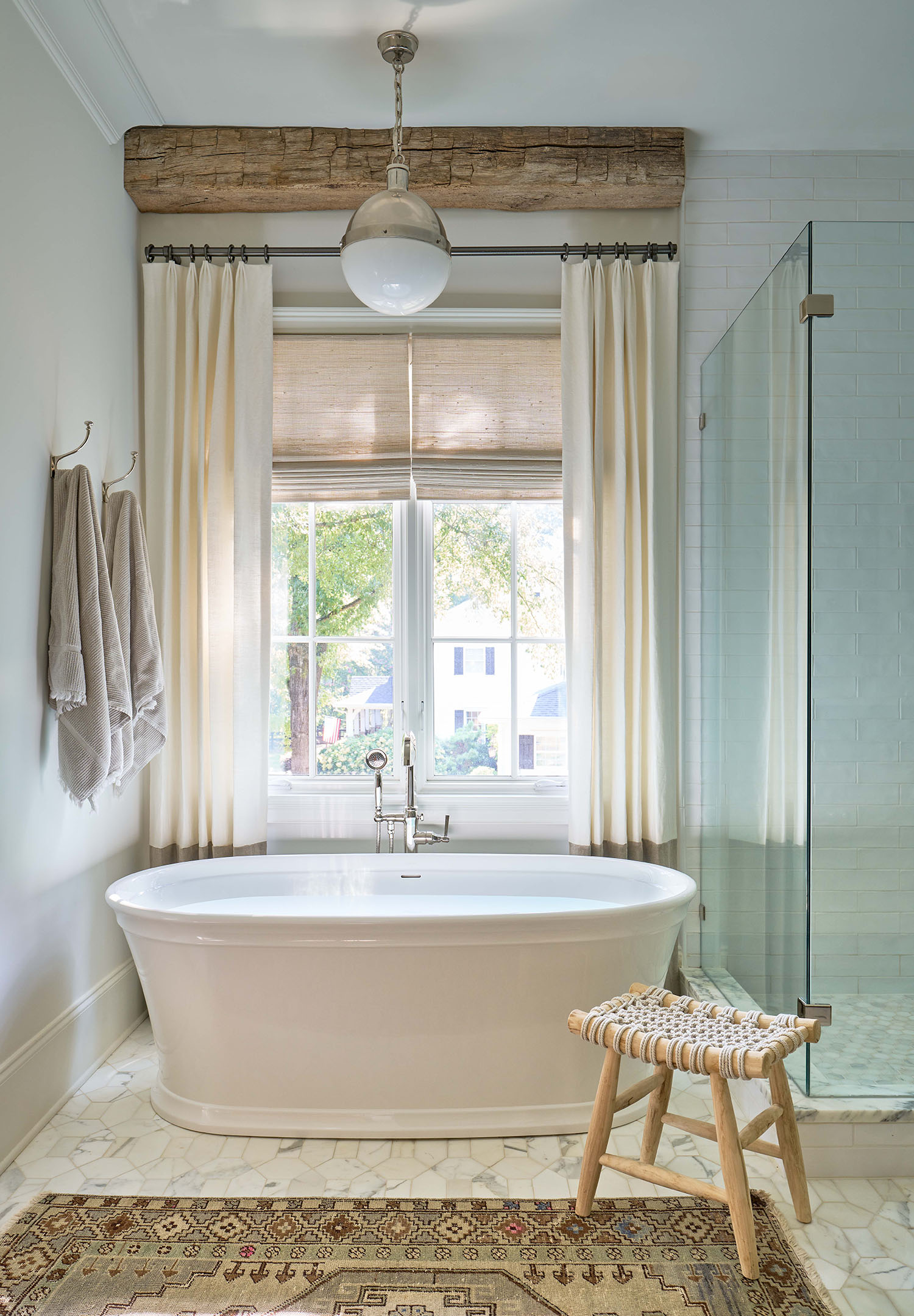 Freestanding bathtub in front of stylized window, luxury custom home in Charlotte, NC