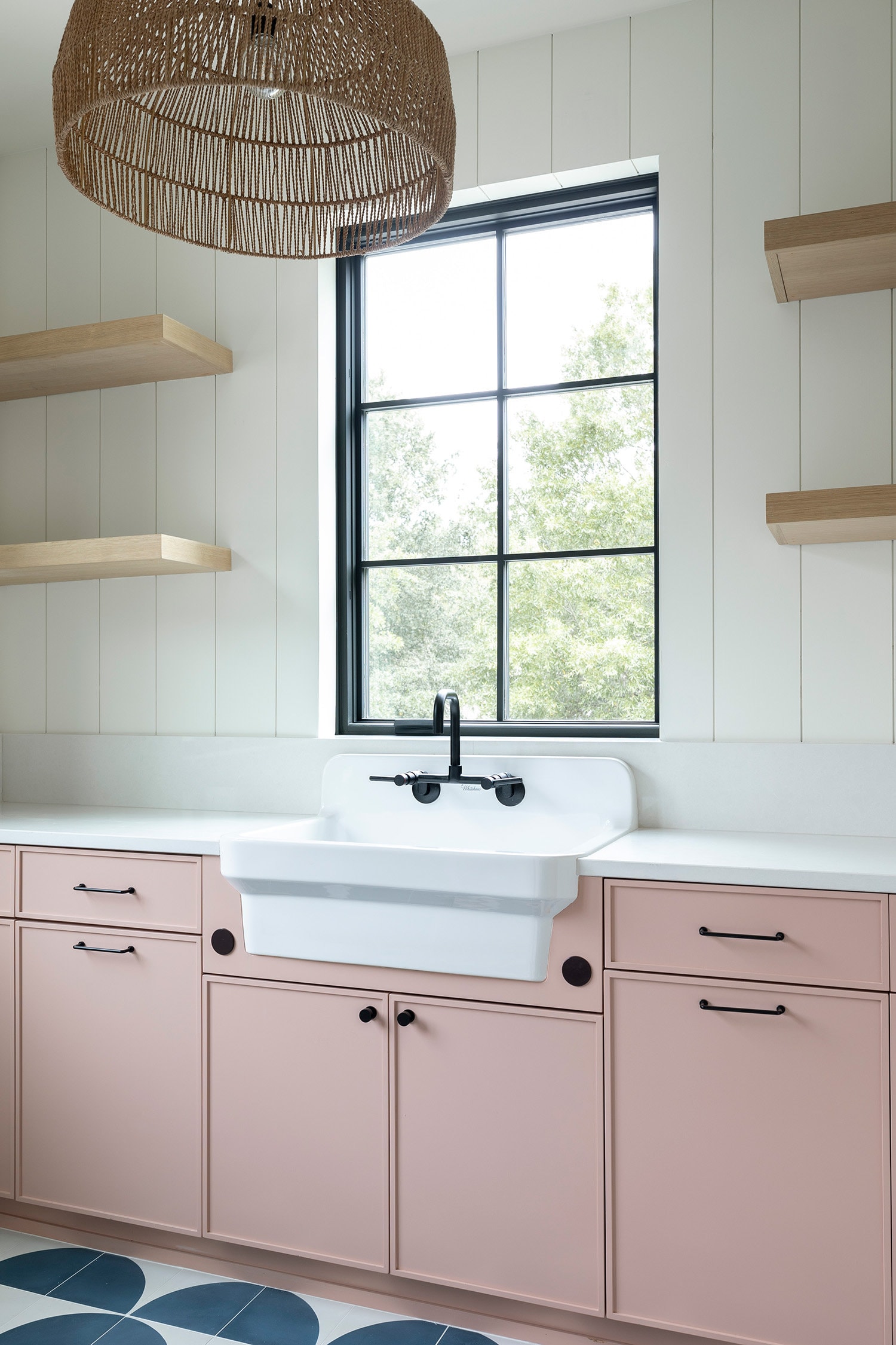 Stylish, farmhouse utility sink in laundry room with pink cabinetry, luxury custom home in Charlotte, NC