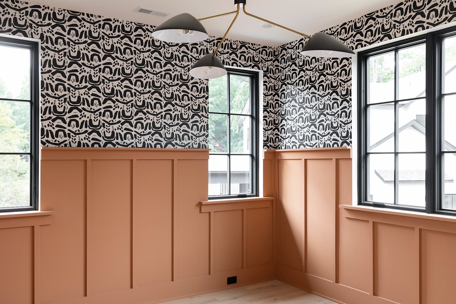 Children's bedroom with wainscoting and black and white wallpaper in luxury custom home, Charlotte, NC